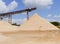 Conveyor belts and sand heaps. Construction industry. Sand quarry. Horizontal photo