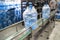 Conveyor line or belt with clean pure drinking water in plastic bottles packed in cellophane, loading finished goods at