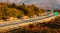 Convoy or caravan of red utility trucks on a highway