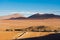 A convoy of cargo trucks crossing an arid desert