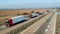 Convoy of transportation trucks passing on a highway