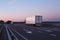 A convoy of trucks trucks transports the cargo in the evening on the highway, the concept of logistics and freight, copy