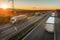 Convoys of transportation trucks passing each other on a highway