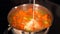 Cook adding milk to a pot of boiled vegetables