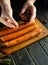 The cook adds aromatic spices to the sausages with his hands before cooking. Work environment on the kitchen table