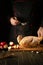 The cook adds paprika to raw duck before roasting in the oven. Cooking a national dish with apples in the restaurant kitchen by