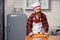 A cook in an apron makes a salad of vegetables and pizza.