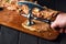 The cook beats off raw veal with a Meat tenderizer. Close-up of the work environment and the hands of the chef on the kitchen