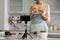 Cook blogger woman in apron cooking salad at web camera