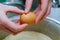 Cook breaking an egg into the bowl in a bakery