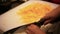 Cook is chopping bell pepper, closeup. Chef finely