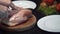 The cook cuts the chicken breast in half, raw chicken, chef cooks chicken breasts, poultry meat, diet meat