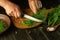 The cook cuts fennel with a knife on a cutting board. Preparing to preserve spices. Close-up of chef hands while working