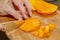 Cook cuts juicy mango into slices for making salad