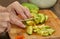 Cook cuts ripe avocado into slices for salad making