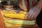 Cook on the cutting board prepares roasted corn cob for the buyer