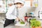 Cook Cutting Scallions In Kitchen