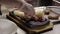 A cook decorates a dish with meat and pita bread in a metal tray.