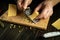 The cook grates hard cheese before preparing a delicious dinner. Low key concept of preparing a cheese dish on a kitchen table in