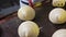 the cook greases croissants with a silicone brush to cover with egg yolk. close-up