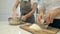 The cook grinds grated cheese and female hands making dough for baking