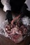 Cook holds a whole octopus in his hands. Octopus tentacles. Seafood dishes. Protein food. An unrecognizable person. Vertical photo