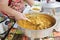 Cook islander woman serving Chicken with coconut cream with rice