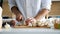 Cook at the kitchen cutting mushrooms