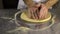 Cook in the kitchen preparing pizza dough. Man prepares pastries