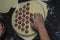 Cook kneads dough on dumplings with minced meat on a special form