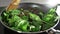 The cook makes vegetable dish with onion fried in balsamic vinegar and adds spinach