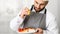 Cook Man Plating Salmon Steak Squeezing Lemon Standing In Kitchen