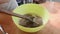 Cook mixes ingredients for dough in plastic bowl