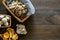 Cook mushrooms concept. Champignons, oysters, chanterelles in basket and on frying pan on dark wooden background top