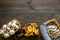 Cook mushrooms concept. Champignons, oysters, chanterelles on cutting board, on frying pan on dark wooden background top