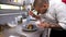 Cook pouring honey over a grilled beef steak