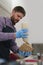 Cook pouring tzatziki sauce in a pita souvlaki in a Greek restaurant. Kitchen worker preparing a sandwich for take away