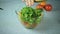 Cook pours in a bowl salad ingredients