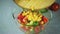 Cook pours in a bowl salad ingredients