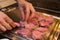 Cook prepared raw meat for barbecue