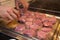 Cook prepared raw meat for barbecue