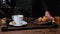 Cook prepares, coffee with croissants. Close-up video shooting, dark background
