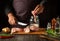 The cook prepares herring in the kitchen from fish steaks and aromatic spices. Canning fish in a jar with salt and coriander