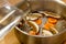 The cook prepares mushroom soup from porcini mushrooms, carrots and herbs