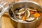 The cook prepares mushroom soup from porcini mushrooms, carrots and herbs