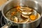 The cook prepares mushroom soup from porcini mushrooms, carrots and herbs