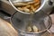 The cook prepares mushroom soup from porcini mushrooms, carrots and herbs