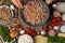 The cook prepares the mushroom stuffing. In the photo, the process of cooking minced meat. On a wooden table - mushrooms, minced