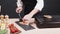 Cook preparing a dish from frying salmon fillet