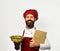 Cook with proud smile in burgundy uniform holds baked dish